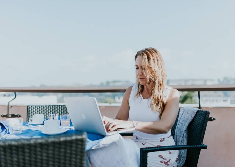 A remote worker working from a rooftop restaurant
