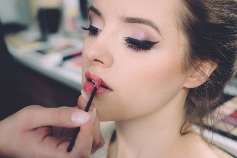 Makeup artist applying lip liner