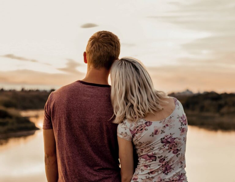 Single girl and boy dating each other near a lake